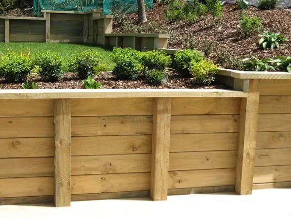 Timber Retaining Walls constructed by Retaining Walls Tauranga, supporting tiered landscaping in a residential garden.