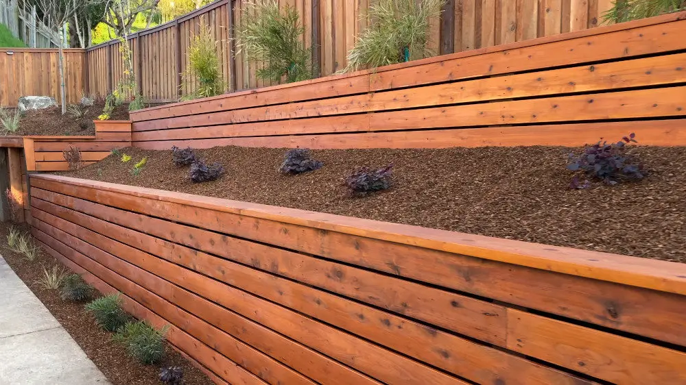 Timber Retaining Walls by Retaining Walls Tauranga showcasing tiered garden beds with clean, modern wood panel construction.