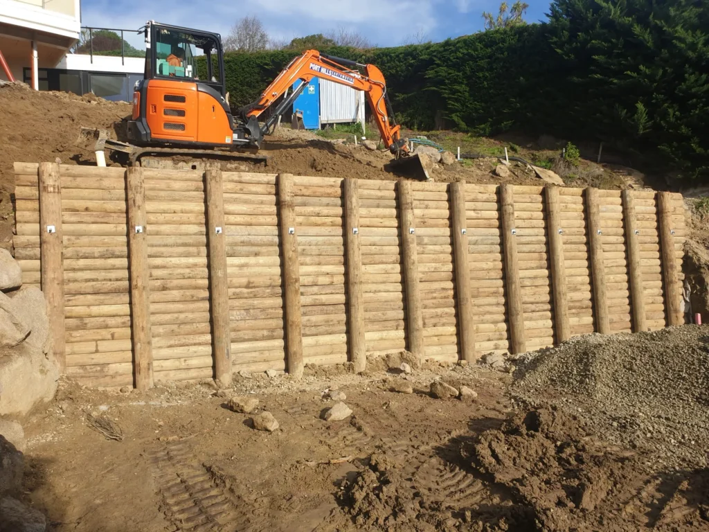 Timber Retaining Walls constructed by Retaining Walls Tauranga during an excavation project to support a steep slope with durable round log posts.